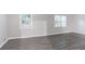 Bright living room featuring modern gray vinyl flooring and plenty of natural light from the large windows at 2046 Copperfield Cir, Decatur, GA 30035