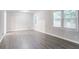 Bright living room featuring modern gray vinyl flooring and plenty of natural light from the large windows at 2046 Copperfield Cir, Decatur, GA 30035