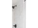 Close up of shower with neutral tiles and dark hardware at 2046 Copperfield Cir, Decatur, GA 30035