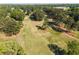 Aerial view featuring a golf course with lush green fairways, trees, and nearby residences at 2316 Echelon Ln, Smyrna, GA 30080