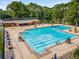 Aerial view of a sparkling community pool with lounge chairs, umbrellas, and a bath house surrounded by mature trees at 2316 Echelon Ln, Smyrna, GA 30080
