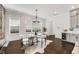 Open dining area with hardwood floors, large windows, and stylish modern furniture at 2316 Echelon Ln, Smyrna, GA 30080