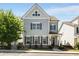 Charming two-story home featuring light blue siding and dark shutters against the backdrop of a clear blue sky at 2316 Echelon Ln, Smyrna, GA 30080
