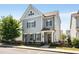 Charming two-story home featuring light blue siding and dark shutters against the backdrop of a clear blue sky at 2316 Echelon Ln, Smyrna, GA 30080