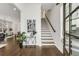 Bright foyer featuring hardwood floors, a staircase, and stylish decor, creating an inviting entrance at 2316 Echelon Ln, Smyrna, GA 30080