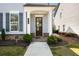Inviting front porch with a dark wood door, white columns, and manicured landscaping, enhancing curb appeal at 2316 Echelon Ln, Smyrna, GA 30080