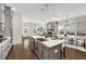 Open concept kitchen with island, stainless appliances, hardwood floors, and an adjacent dining area at 2316 Echelon Ln, Smyrna, GA 30080