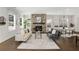 Spacious living room with a brick fireplace, large windows, and modern furnishings, offering a cozy atmosphere at 2316 Echelon Ln, Smyrna, GA 30080