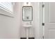Powder room features a pedestal sink, modern fixtures, and natural light at 2316 Echelon Ln, Smyrna, GA 30080
