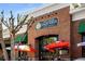 The Corner Taqueria with bright red umbrellas, large windows, and brick facade presents a vibrant dining experience at 2316 Echelon Ln, Smyrna, GA 30080