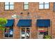Blue Moon Pizza restaurant with blue awnings, brick facade, and large windows provides a classic, neighborhood feel at 2316 Echelon Ln, Smyrna, GA 30080