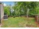 A spacious backyard with lush green grass, mature trees, and a wooden fence provides a serene outdoor space at 2864 White Oak Dr, Decatur, GA 30032