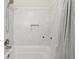 Modern bathtub with a tiled shower featuring a built-in niche and shower curtain for a clean and minimalist look at 2864 White Oak Dr, Decatur, GA 30032