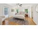 Bright bedroom featuring hardwood floors, neutral walls, fan and a door to the backyard at 2864 White Oak Dr, Decatur, GA 30032