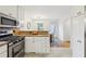 Kitchen showcases stainless steel appliances, tile floor, and leads to dining room at 2864 White Oak Dr, Decatur, GA 30032