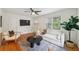 Cozy living room with white sofa, area rug, hardwood floors, ceiling fan and modern decor at 2864 White Oak Dr, Decatur, GA 30032