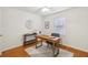 Home office with hardwood floors, fan and modern desk and chair at 2864 White Oak Dr, Decatur, GA 30032