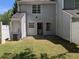 Small backyard with light blue siding, a door, and a small patio at 3789 Waldrop Ln, Decatur, GA 30034