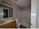 Bathroom featuring a sink, toilet, and bathtub with white tiles at 3789 Waldrop Ln, Decatur, GA 30034