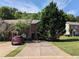 Townhome with brick facade, driveway, and mature landscaping in a residential neighborhood at 3789 Waldrop Ln, Decatur, GA 30034
