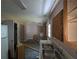 View of the kitchen and living room with damaged walls and debris at 3789 Waldrop Ln, Decatur, GA 30034