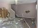 Spacious living room with wall to wall carpet, damaged walls and stairway at 3789 Waldrop Ln, Decatur, GA 30034
