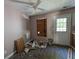 Room with door, laminate floors, and plywood covered window at 3789 Waldrop Ln, Decatur, GA 30034