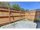 Fenced backyard with a concrete area, landscaping, and string lights at 5554 Clover Rise Ln, Norcross, GA 30093
