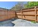Fenced backyard with a concrete area, landscaping, and string lights at 5554 Clover Rise Ln, Norcross, GA 30093