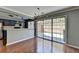 Dining space featuring hardwood floors and sliding glass doors leading to the backyard at 5554 Clover Rise Ln, Norcross, GA 30093