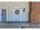 Up close front door, showcasing brick chimney, and wreath on door at 5554 Clover Rise Ln, Norcross, GA 30093