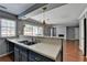 A kitchen showcases modern appliances, countertops, and a breakfast bar to the living room at 5554 Clover Rise Ln, Norcross, GA 30093