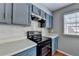 A kitchen showcases modern appliances, backsplash, countertops, and cabinets at 5554 Clover Rise Ln, Norcross, GA 30093