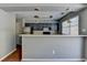 A modern kitchen features stainless steel appliances and a stylish breakfast bar at 5554 Clover Rise Ln, Norcross, GA 30093