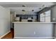 A modern kitchen features stainless steel appliances and a stylish breakfast bar at 5554 Clover Rise Ln, Norcross, GA 30093