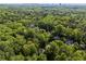 Aerial view of homes nestled within a lush green forest, offering privacy and serenity with city views at 1169 Dawn View Nw Ln, Atlanta, GA 30327
