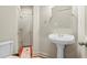 Half-bathroom features classic pedestal sink and tile accents at 1169 Dawn View Nw Ln, Atlanta, GA 30327