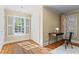 Bedroom with hardwood floors, white trim, and window with white shutters at 1169 Dawn View Nw Ln, Atlanta, GA 30327