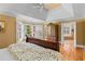 Bright bedroom featuring hardwood floors, neutral walls, shuttered windows, and access to bath at 1169 Dawn View Nw Ln, Atlanta, GA 30327