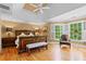 Spacious primary bedroom with tray ceiling, large windows with shutters, and hardwood floors at 1169 Dawn View Nw Ln, Atlanta, GA 30327
