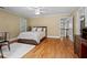 Bedroom featuring hardwood floors, white bedding, and window with white shutters at 1169 Dawn View Nw Ln, Atlanta, GA 30327