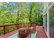 A spacious deck with outdoor furniture offers a serene view of the surrounding greenery at 1169 Dawn View Nw Ln, Atlanta, GA 30327