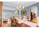 Elegant dining room with hardwood floors, large windows and decorative chandelier at 1169 Dawn View Nw Ln, Atlanta, GA 30327