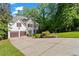 Beautiful two-story home with a two-car garage, landscaped yard, and lush greenery at 1169 Dawn View Nw Ln, Atlanta, GA 30327