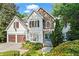 Charming two-story home featuring a stone accent wall, two car garage, and well-manicured landscaping at 1169 Dawn View Nw Ln, Atlanta, GA 30327