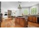 Open concept kitchen with island cooktop seamlessly flows to dining and living room with fireplace at 1169 Dawn View Nw Ln, Atlanta, GA 30327
