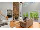 Spacious living room has stone fireplace, built-in shelves, and abundant natural light at 1169 Dawn View Nw Ln, Atlanta, GA 30327