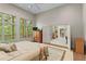 This bright bedroom features a wall of windows overlooking a deck and a carpet flooring at 1169 Dawn View Nw Ln, Atlanta, GA 30327