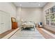 Bright main bedroom featuring a ceiling fan, a plush rug and large windows overlooking the trees at 1169 Dawn View Nw Ln, Atlanta, GA 30327