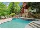 Gorgeous backyard pool area with stone features and steps, ideal for outdoor gatherings at 1169 Dawn View Nw Ln, Atlanta, GA 30327